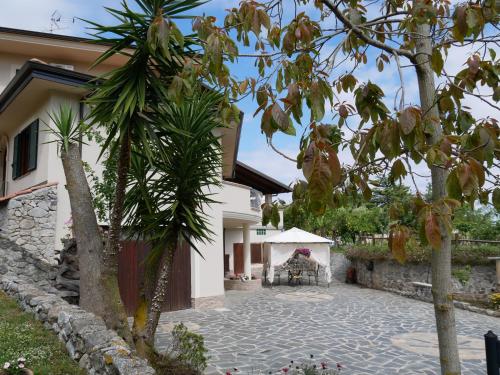 a courtyard of a house with trees and a building at B & B Korello in Gasponi