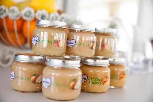 a group of jars of honey on a counter at Hotel Virginia in Diano Marina