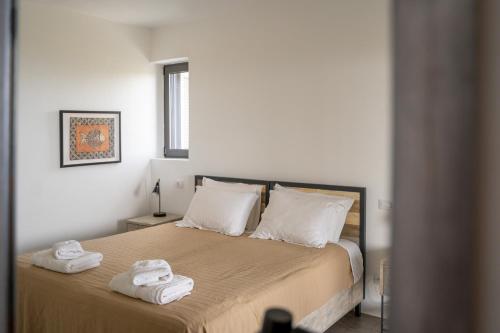 a bedroom with a bed with towels on it at Agrikea in Korissia