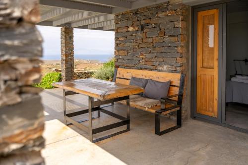 a wooden bench sitting on the porch of a house at Agrikea in Korissia