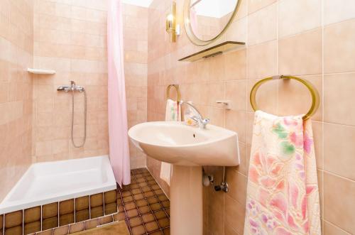 a bathroom with a sink and a shower and a mirror at Rooms Mozara in Trsteno