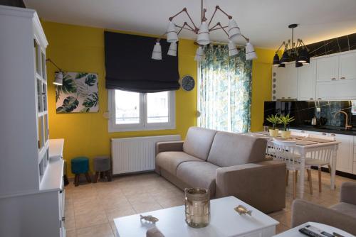 a living room and kitchen with a couch and a table at Ikies Luxury Apartments in Ofrínion