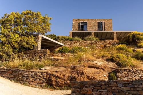 a house on a hill with a stone wall at Agrikea in Korissia