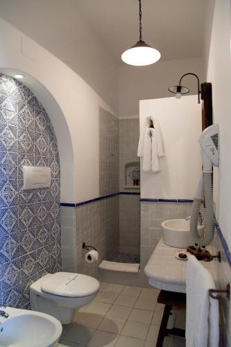 a bathroom with a toilet and a sink at Quartara Boutique Hotel in Panarea