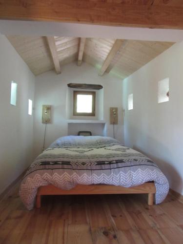 a large bed in a room with a window at Gîte Le Petit Nid in Portes