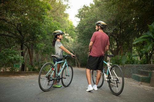 a man and a woman standing next to their bikes at Lavendish Lake Giritale in Polonnaruwa
