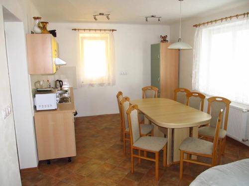 a kitchen and dining room with a table and chairs at Holiday Home U Čápů in Klec