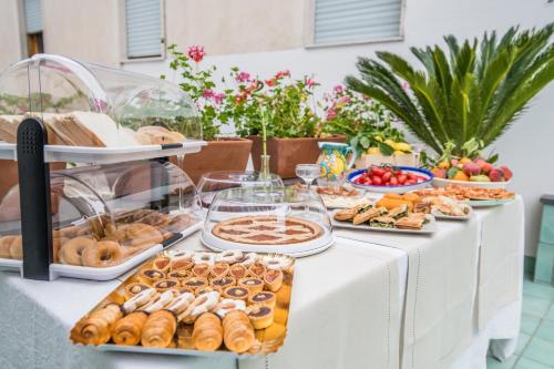 a buffet of pastries and other food on a table at Valle d'Amalfi Suites in Amalfi