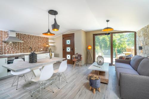 a kitchen and living room with a couch and a table at Natura Bungalows-Villa in Limenas