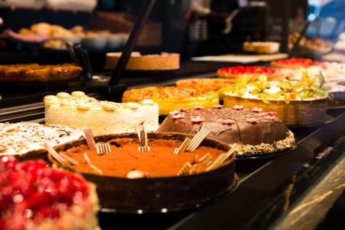a buffet filled with different types of cakes and pies at Gästehaus Rössler in Brannenburg