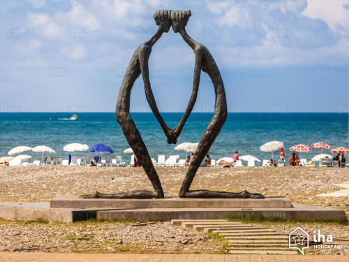 a statue of two people standing in front of the beach at Cheap and Chic in Batumi