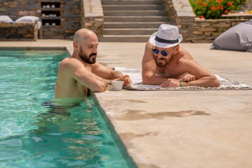 two men sitting in a swimming pool at Agrikea in Korissia