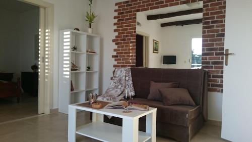 a living room with a couch and a table at Apartments Mare in Hvar