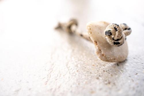 a rock with a knot in it on a chain at Agrikea in Korissia