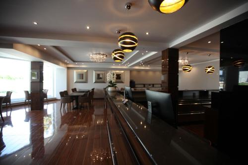 a dining room and living room with a bowling alley at Hotel Starton am Ingolstadt Village in Ingolstadt