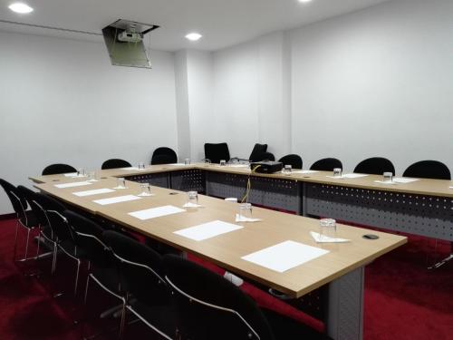 a conference room with a long table and chairs at Lalla Doudja Hotel in Alger