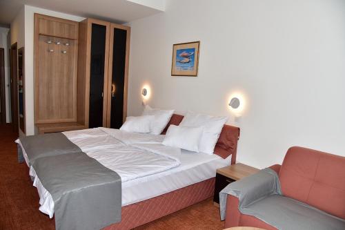 a hotel room with a bed and a couch at Hotel Makpetrol Struga in Struga
