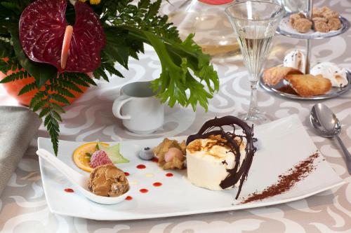 a white plate with a dessert on a table at Le Rhien Hôtel-Restaurant in Ronchamp