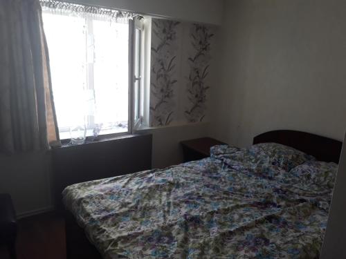 a bedroom with a bed and a window at Pensiunea Red Rock in Piatra Neamţ