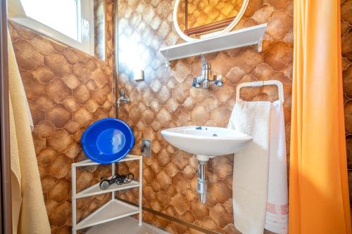 a bathroom with a sink and a mirror at Apartments Klavdija in Vodice