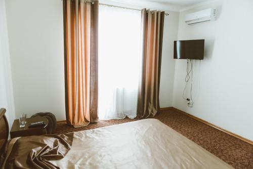 Ένα ή περισσότερα κρεβάτια σε δωμάτιο στο Hotel Korona
