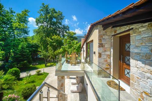 an external view of a house with a balcony at Natura Bungalows-Villa in Limenas