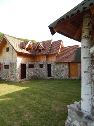 an old house with wooden roofs and a yard at Staparski Sorrento in Užice