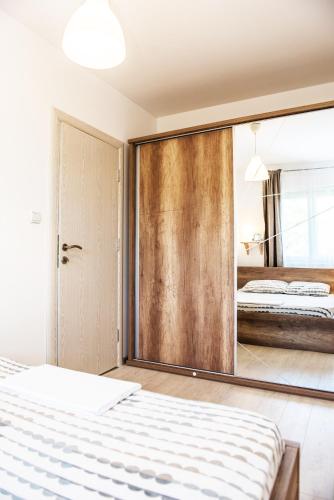 a bedroom with a large mirror and a bed at Apartment Sea&Sky in Tivat