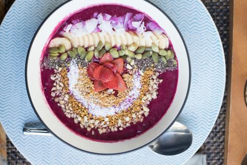 a bowl of food on a plate on a table at Kaleydo Villas in Gili Trawangan