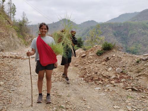 two women walking down a dirt road with a plant at Jaadooghar Maatre Yoga Retreat in Marchula