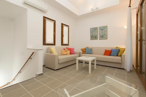 a living room with two couches and a table at Functional house by the sea at Ierissos in Ierissos