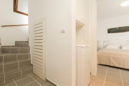 a small bedroom with a bed and a bathroom at Functional house by the sea at Ierissos in Ierissos