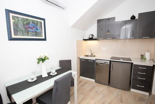 a kitchen with a table and a dining room at Old Town Apartment Split in Split