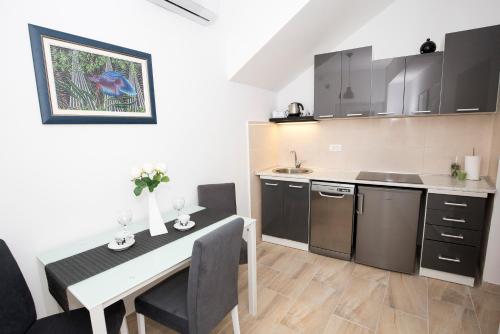 a kitchen with a table and a dining room at Old Town Apartment Split in Split