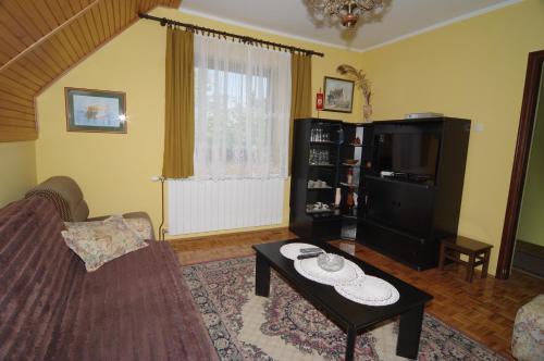 a living room with a couch and a coffee table at Guest House Sveti Marko Gacka in Otočac