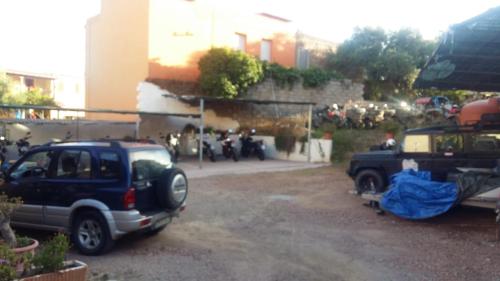 a car parked in a parking lot next to a building at Hotel Plammas in Santa Maria Navarrese