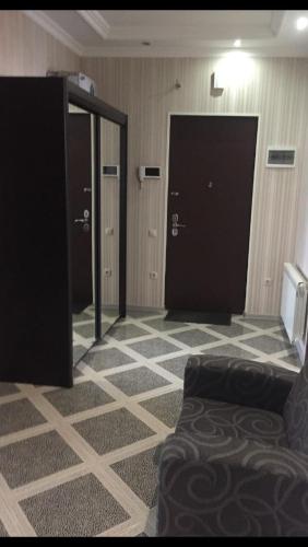 a room with two doors and a couch in a room at David Apartment in Tbilisi City