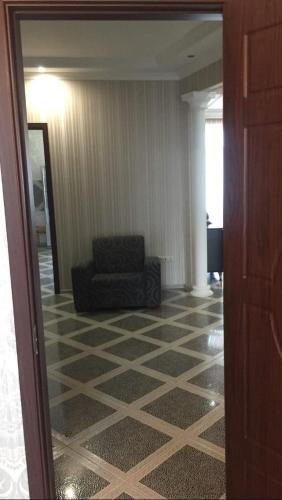 a living room with a chair and a couch at David Apartment in Tbilisi City