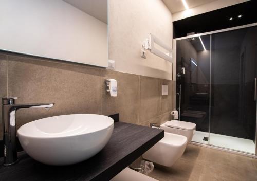 
a bathroom with a sink, toilet and bathtub at Astoria Living Apartments in Bologna
