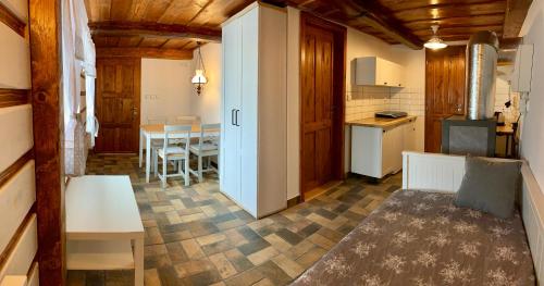a living room with a kitchen and a dining room at Chalupa na Horce in Blata