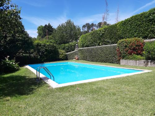 a swimming pool in the middle of a yard at Casa Da Espinhosa in Guimarães