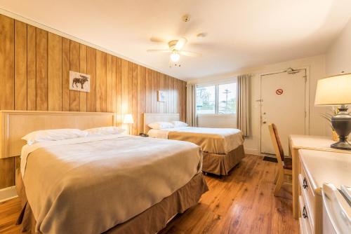 a hotel room with two beds and a window at Lake City Motel in Halifax