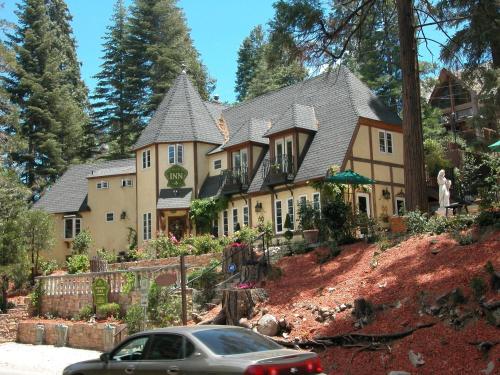 a large house with a car parked in front of it at FLEUR DE LAC EUROPERAN INn in Lake Arrowhead
