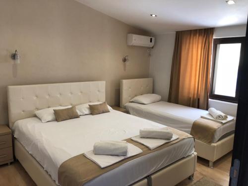 a bedroom with two beds and a window at Days Inn Apartments in Ulcinj