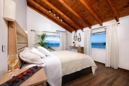 a bedroom with a bed with a view of the ocean at Corfu Seaview Maisonette - Sopra il Mare in Petrití