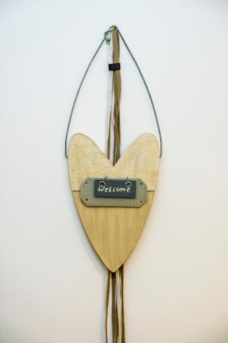 a wooden heart ornament hanging on a wall at Margarita Apt - Amazing Relaxing View in Megála Khoráfia