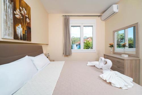 a bedroom with a bed with a stuffed animal on it at Theodore Apartments in Skala Marion