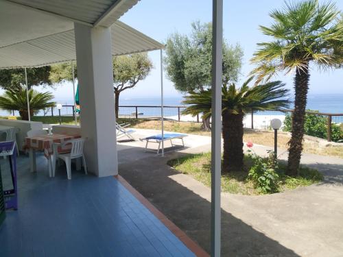a porch with a table and a view of the ocean at La Dea del Mare in Ischia