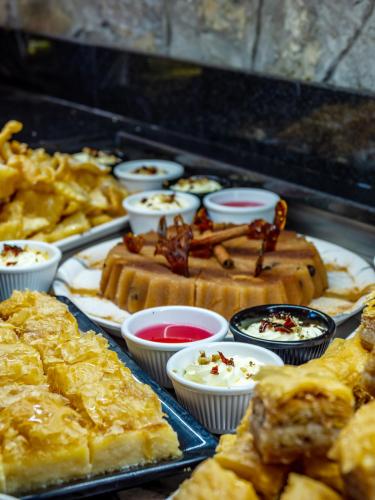 a buffet of food with hot dogs and other foods at Paleo ArtNouveau Hotel - Adults Only in Paleokastritsa