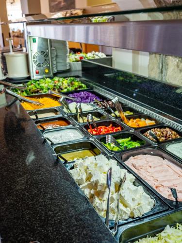 a buffet line with many different types of food at Paleo ArtNouveau Hotel - Adults Only in Paleokastritsa